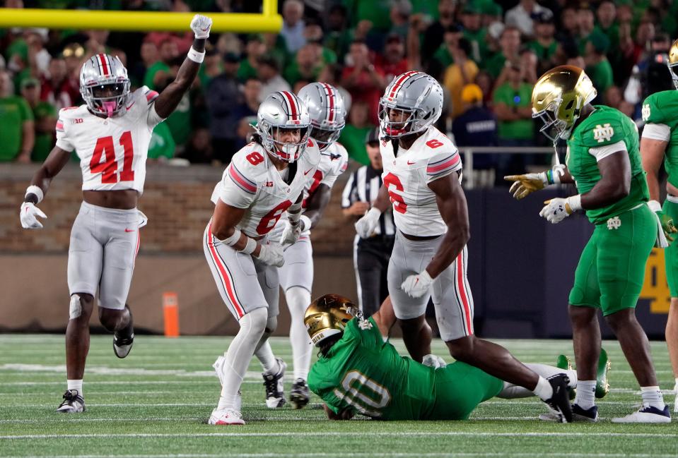 Sep 23, 2023; South Bend, Indiana, USA; Ohio State Buckeyes safety Lathan Ransom (8) stops Notre Dame Fighting Irish quarterback Sam Hartman (10) on fourth down during the third quarter of their game at Notre Dame Stadium.