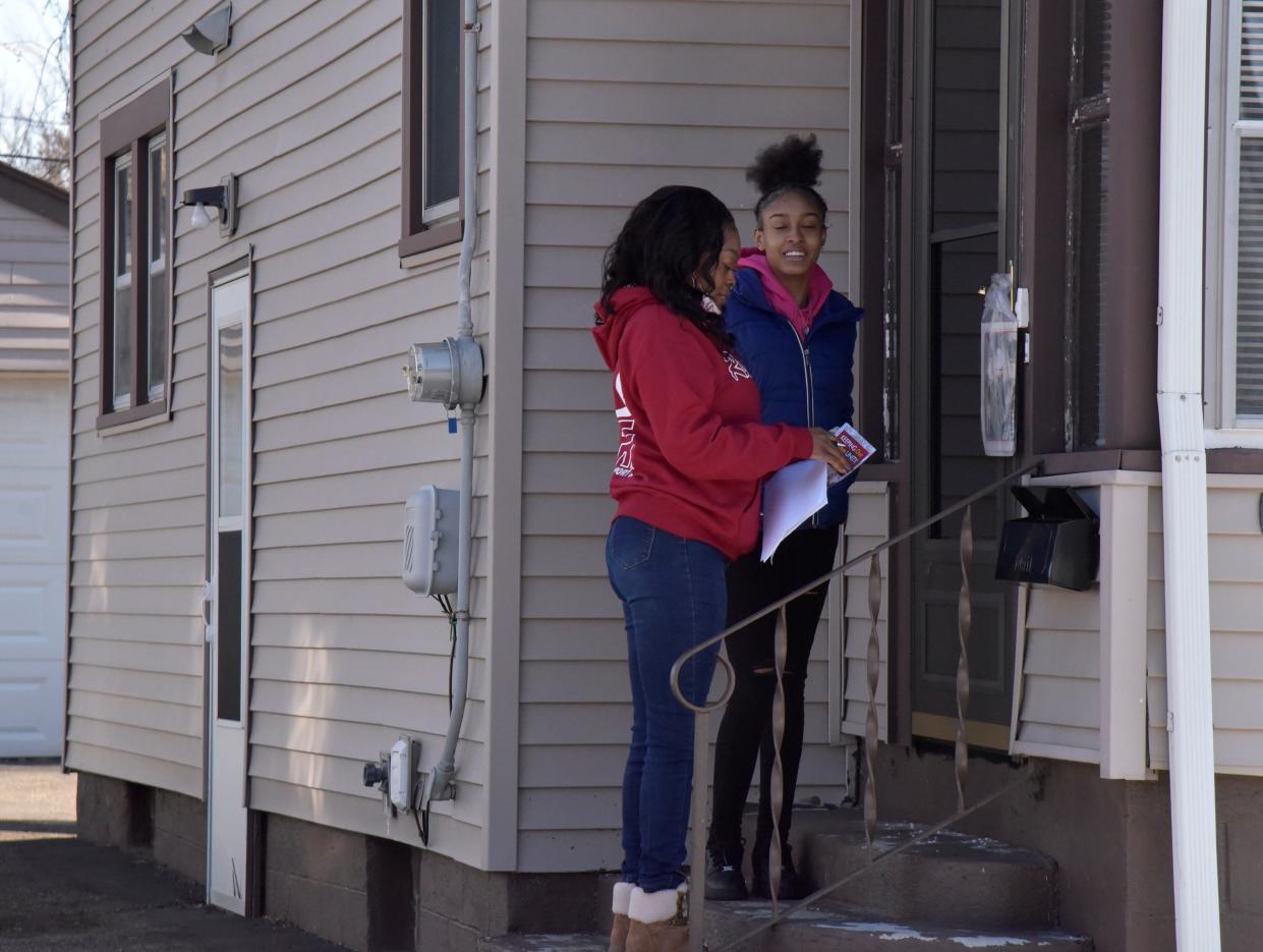 Nakisha Newton and her daughter, Amiyah Hollins, knock on doors along Hubbard Street in Battle Creek soliciting residents to install free Ring 3 doorbells and subscriptions via the nonprofit RISE Corp on Friday, Jan. 21, 2022.
