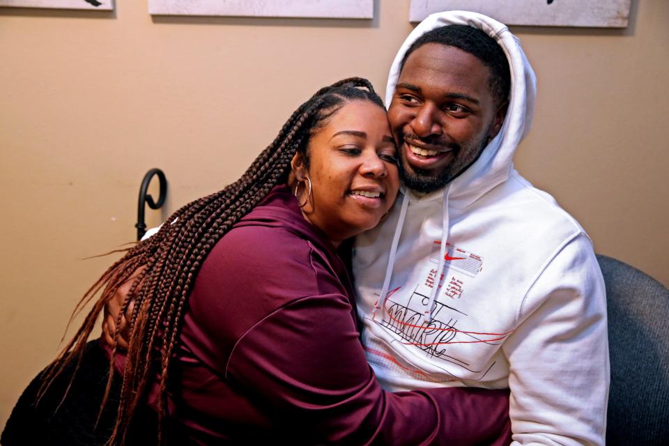 Tyanna Cates, left, Marlin Dixon's girlfriend, hugs him at his apartment in Menomonee Falls, Wis. The two met the second day of his release from John C. Burke Correctional Center.