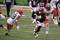 Cincinnati Bengals' Tyler Boyd (83) runs past Cleveland Browns' Kevin Johnson (28) during the second half of an NFL football game, Sunday, Oct. 25, 2020, in Cincinnati. (AP Photo/Michael Conroy)