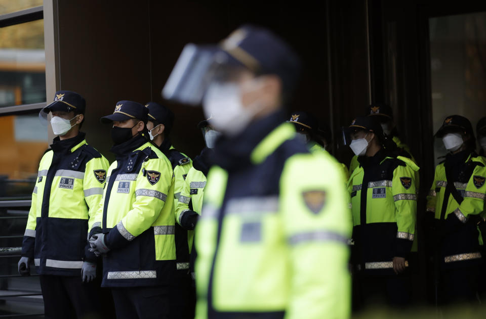 South Korean police officers wearing face masks as a precaution against the coronavirus, stand guard in Seoul, South Korea, Friday, Oct. 30, 2020. (AP Photo/Lee Jin-man)