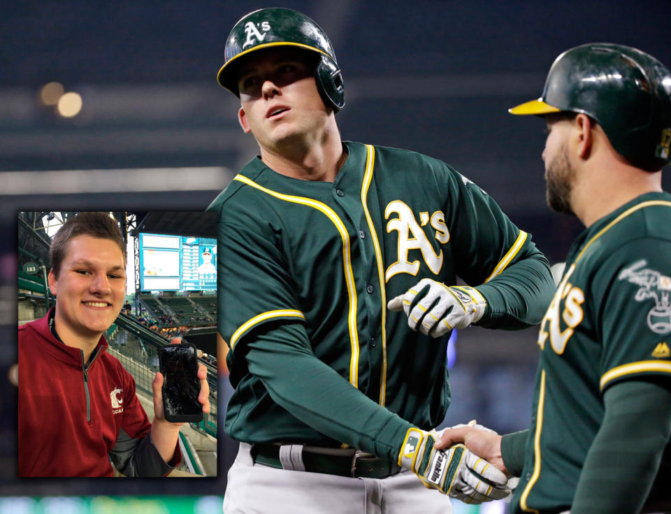 A huge homer by A's slugger Ryon Healy, center, led to a fan's broke fan, left. (AP/@meatpie97)