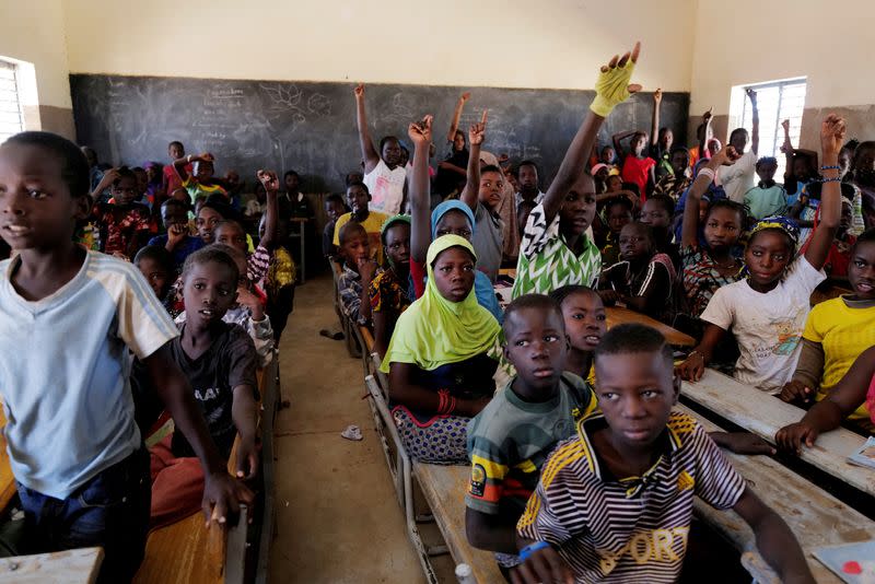 FILE PHOTO: Schoolchildren who fled from attacks of armed militants in Sahel region attend a class in Dori