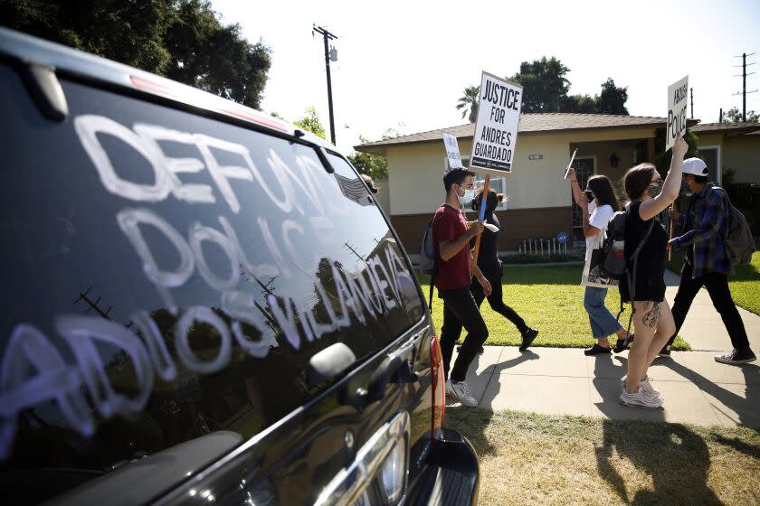 LOS ANGELES, CA - AUGUST 02: Protestors march in a picket organized by the Coalition for Community Control Over the Police at the home of Los Angeles Sheriff's deputy Miguel Vega, who fatally shot Andres Guardado in Covina on Sunday, Aug. 2, 2020 in Los Angeles, CA. (Dania Maxwell / Los Angeles Times)