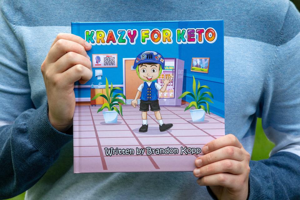 Brandon Kopp, 17, of Marlboro displays his children's book, Krazy for Keto, which he published in January about how he overcame severe epilepsy through diet in Marlboro, NJ Monday April 24, 2023. 