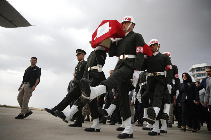 Turkish soldiers carry the Turkish flag-draped coffin of soldier Sefa Findik, killed in action in Syria earlier in the day, during a ceremony at the airport in Sanliurfa, southeastern Turkey, Sunday, Oct. 20, 2019. This death brings Turkey's military death toll to seven soldiers in its wide-ranging offensive against Syrian Kurdish forces.(AP Photo/Lefteris Pitarakis)