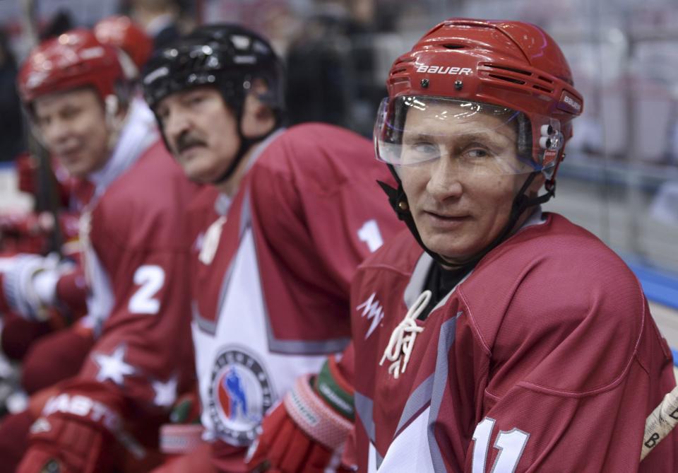 Russian President Vladimir Putin (R) and his Belarussian counterpart Alexander Lukashenko (C) take part in a friendly ice hockey match in the Bolshoi Ice Palace near Sochi January 4, 2014. REUTERS/Alexei Nikolskiy/RIA Novosti/Kremlin (RUSSIA - Tags: POLITICS SPORT OLYMPICS ICE HOCKEY) ATTENTION EDITORS - THIS IMAGE HAS BEEN SUPPLIED BY A THIRD PARTY. IT IS DISTRIBUTED, EXACTLY AS RECEIVED BY REUTERS, AS A SERVICE TO CLIENTS