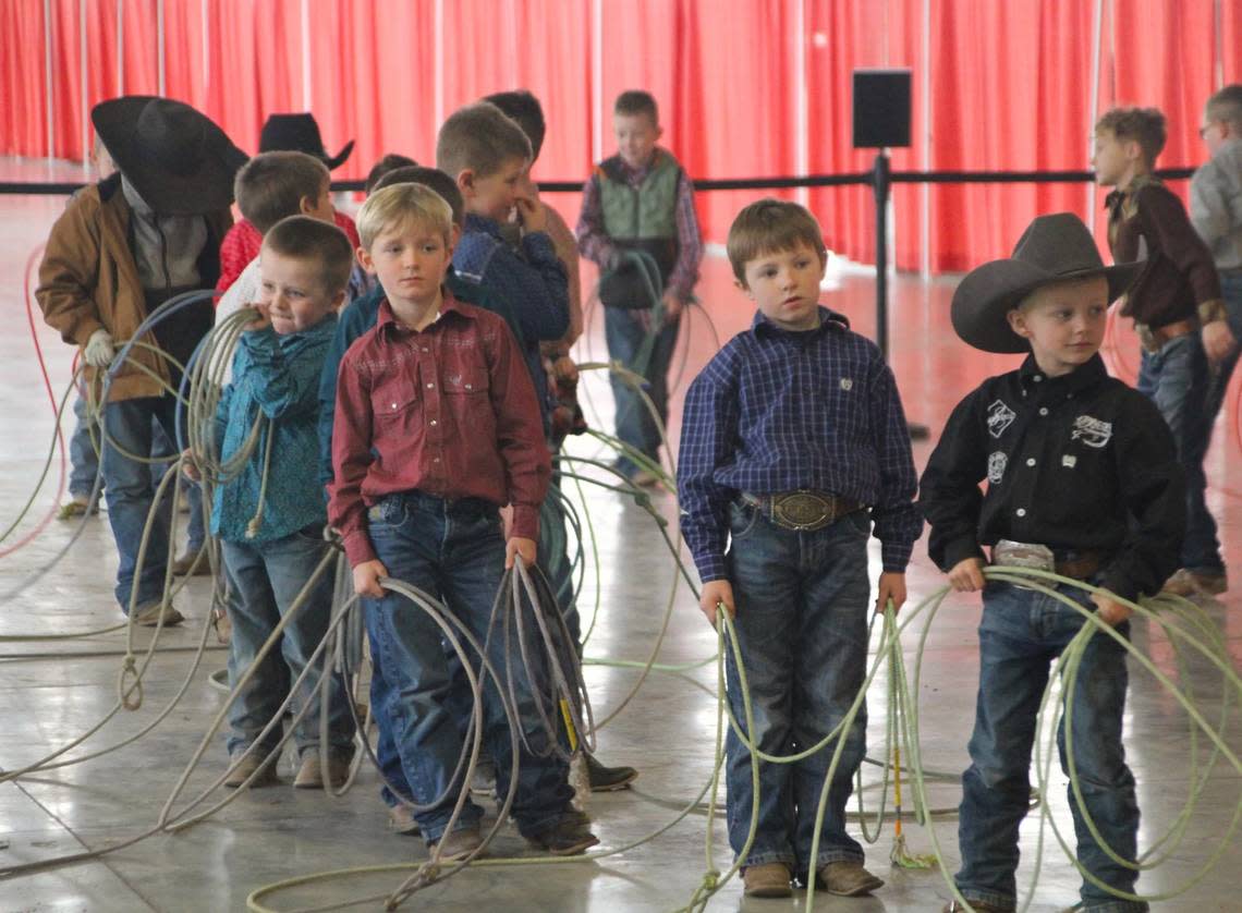 Young competitors wait to begin the dummy roping event at the Young Guns rodeo. In this event, boys ages six and under compete to see who can consistently rope their lasso around a fake steer head.