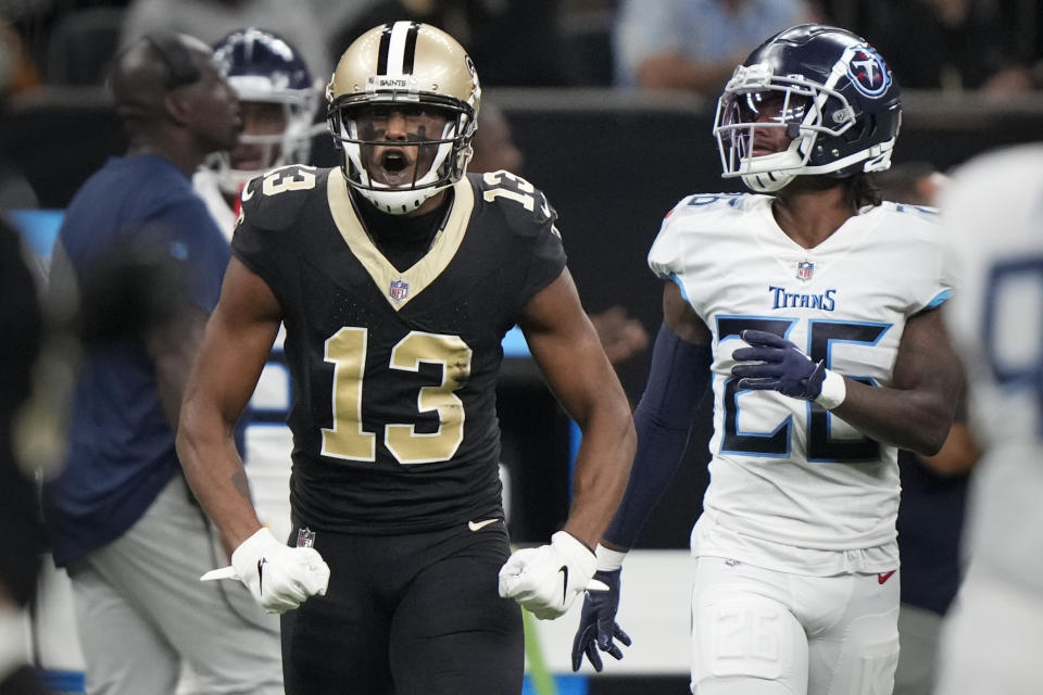 New Orleans Saints wide receiver Michael Thomas (13) celebrates a first down catch over Tennessee Titans cornerback Kristian Fulton, right, in the first half of an NFL football game in New Orleans, Sunday, Sept. 10, 2023. (AP Photo/Gerald Herbert)