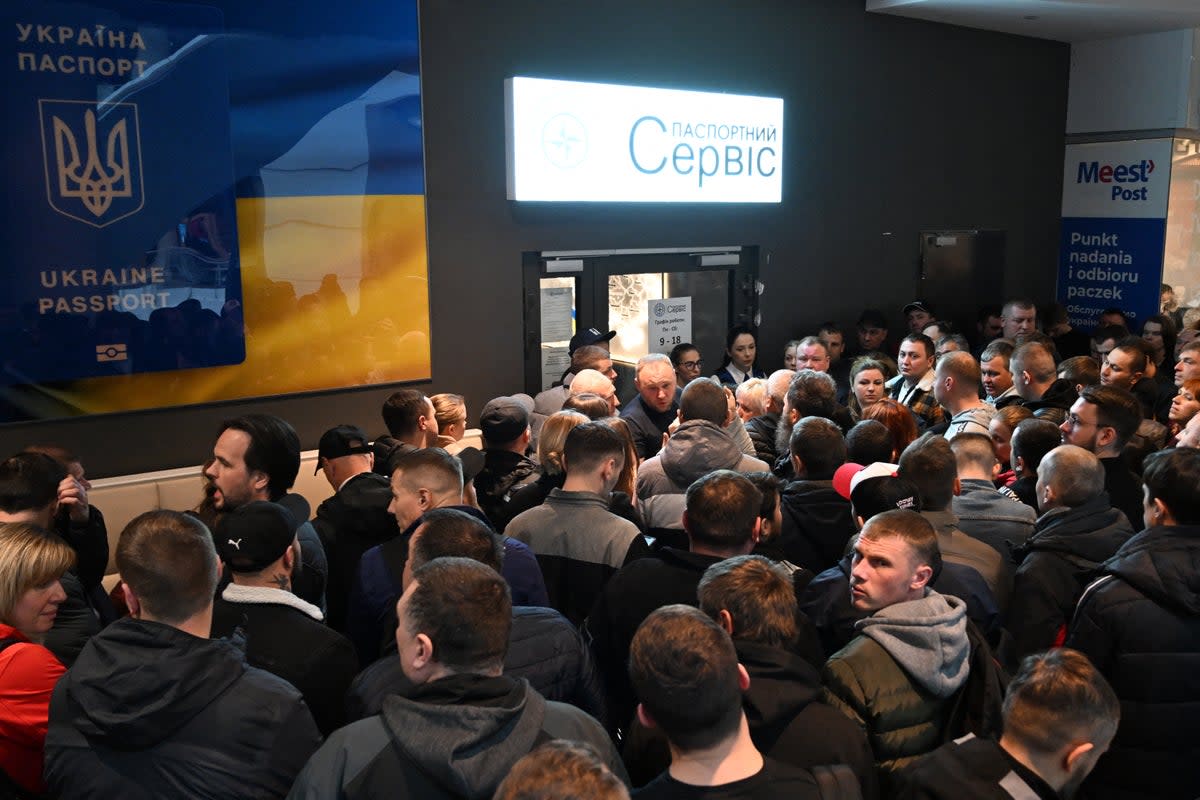 Ukrainians gather in front of a closed Ukraine’s passport service point at the shopping center in Warsaw, Poland (AFP via Getty Images)