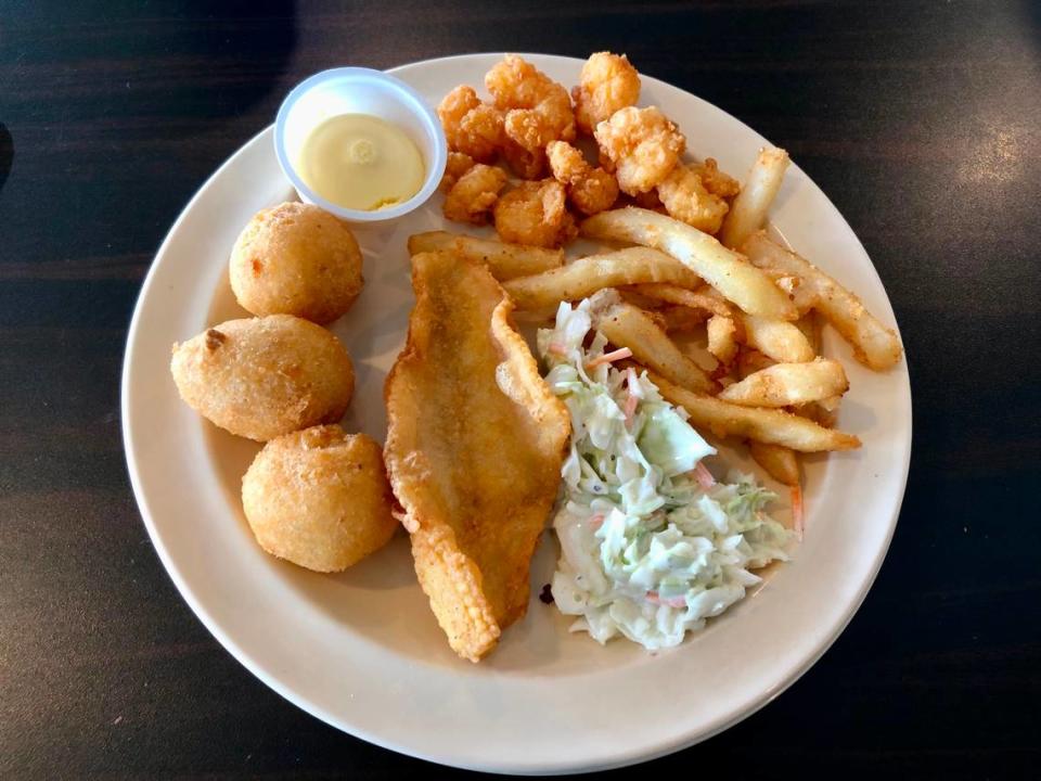 Popcorn shrimp, fries, coleslaw, fried flounder, hush puppies and honey butter at Captain Benjamin’s Calabash Seafood Buffet in Myrtle Beach, SC. Calabash-style fried fish can be found in North and South Carolina and beyond. July 28, 2023.