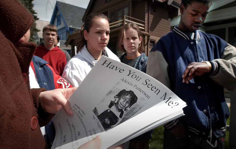 Student volunteers from El Puente High School in Milwaukee gather in front of Alexis Patterson's home ready to distribute posters and help in the search for the missing girl on May 7, 2002.