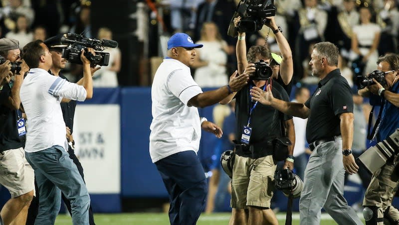 BYU head coach Kalani Sitake and Utah Utes head coach Kyle Whittingham shake hands after the game at LaVell Edwards Stadium in Provo on Saturday, Sept. 9, 2017.