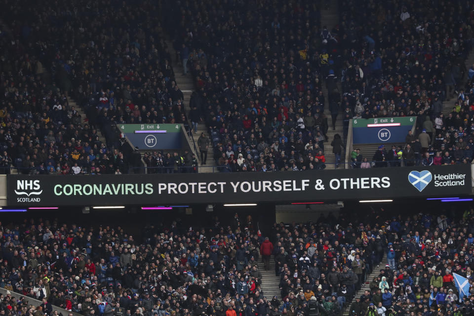 A message that reads: "Coronavirus protect yourself and others" is displayed during the Six Nations rugby union international match between Scotland and France at the Murrayfield stadium in Edinburgh, Scotland, Sunday, March 8, 2020. (AP Photo/Scott Heppell)