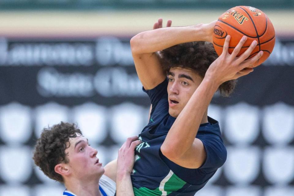 Great Crossing’s 7-foot-1 junior Malachi Moreno, right, finished with 11 points, eight rebounds and five assists with Kentucky head coach John Calipari in attendance on Tuesday night. UK is one of numerous basketball powers who have offered scholarships to Moreno.