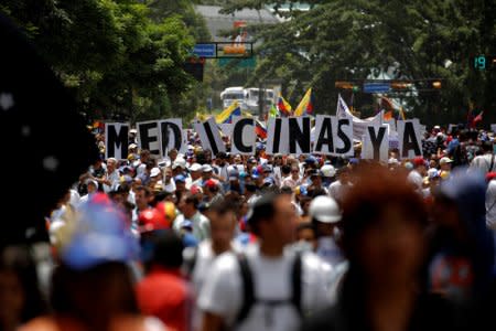 Demonstrators hold a banner that reads