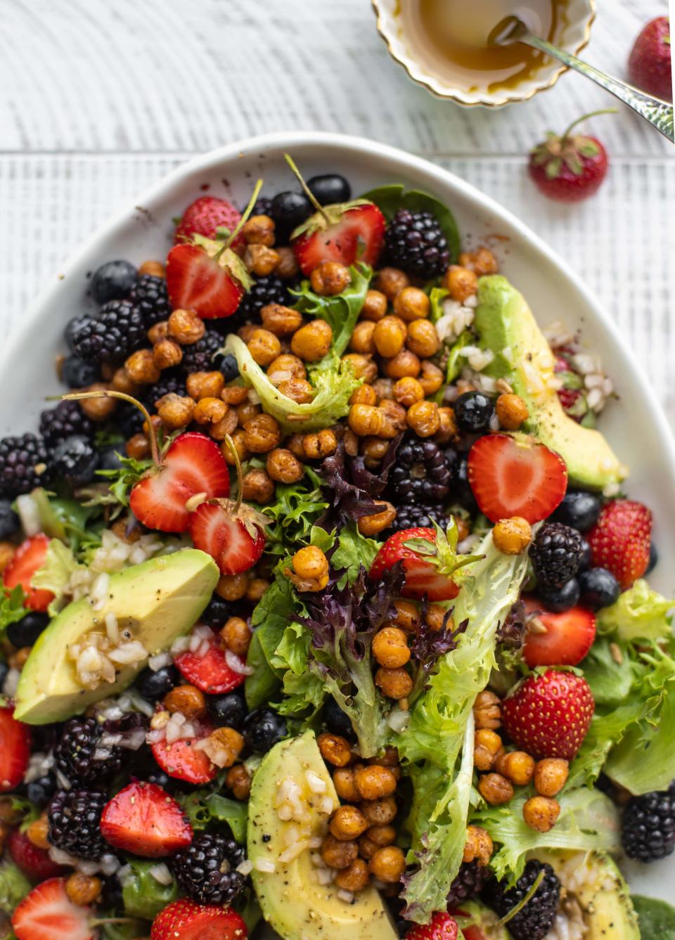 <p>It’s hard to decide what the best ingredient is in this salad—is it the berries, or is it the roasted cinnamon chickpeas? Luckily, you don’t have to decide.</p> <p>Get the recipe <a href="https://www.howsweeteats.com/2020/07/triple-berry-salad/" rel="nofollow noopener" target="_blank" data-ylk="slk:here;elm:context_link;itc:0;sec:content-canvas" class="link ">here</a>.</p>