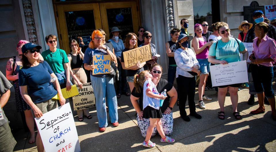 Carter McAbee gives her mother, Jessica McAbee, a kiss during the Bans Off Our Bodies rally at the Monroe County Courthouse on Saturday, May 14, 2022. "I'm doing this for her," Jessica said.