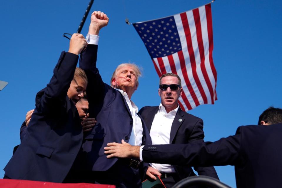 This image of former President Trump raising his fist triumphantly after he survived an assassination attempt in Pennsylvania was snapped by Evan Vucci of the Associated Press. AP
