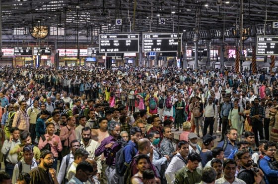 Daily commuters wait for the suburban train on the platform of CST station in Mumbai on April 17. India has a young, vast work force that is expanding as China's ages and shrinks. But the country's immense size also lays bare its enormous challenges. <span class="copyright">Atul Loke—The New York Times/Redux</span>