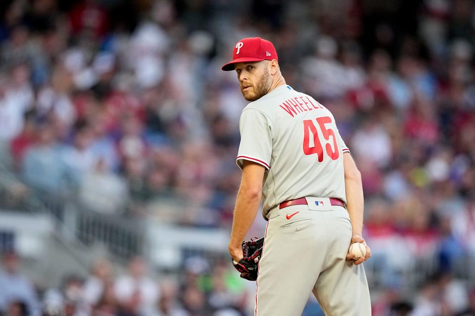 Philadelphia Phillies starting pitcher Zack Wheeler (45) checks the runner at first base in the second inning of Game 2 of a baseball NL Division Series against the Atlanta Braves, Monday, Oct. 9, 2023, in Atlanta. (AP Photo/Brynn Anderson)