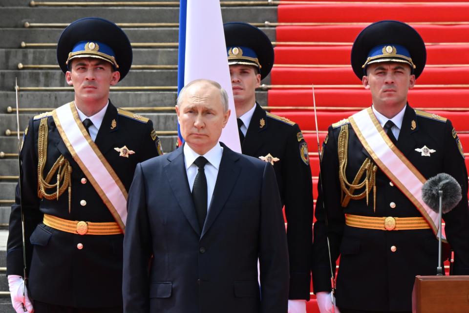 Russian President Vladimir Putin listens to the national anthem prior to delivering a speech to the units of the Russian Defense Ministry, the Russian National Guard (Rosgvardiya), the Russian Interior Ministry, the Russian Federal Security Service and the Russian Federal Guard Service, who ensured order and legality during the mutiny, at the Kremlin in Moscow, Russia, Tuesday, June 27, 2023. (Sergei Guneyev, Sputnik, Kremlin Pool Photo via AP)