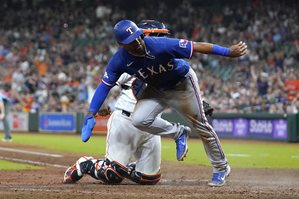 Texas Rangers' Ezequiel Duran, right, is tagged out at home plate by Houston Astros catcher Martin Maldonado during the seventh inning of a baseball game Wednesday, Aug. 10, 2022, in Houston. (AP Photo/David J. Phillip)