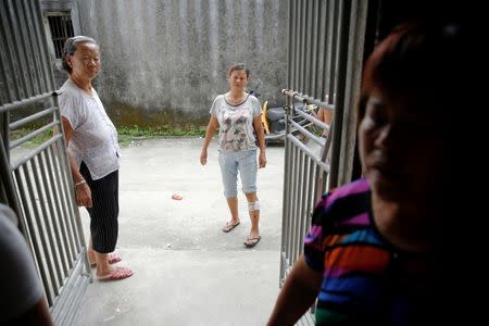 An injured woman and other villagers tell their experience after Tuesday's clashes between security forces and protesters in Wukan, Guangdong province, China, September 14, 2016. REUTERS/Damir Sagolj