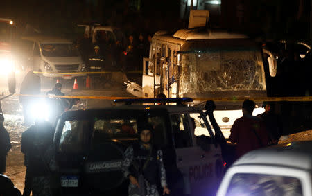 Police officers inspect a scene of a bus blast in Giza, Egypt, December 28, 2018. REUTERS/Amr Abdallah Dalsh