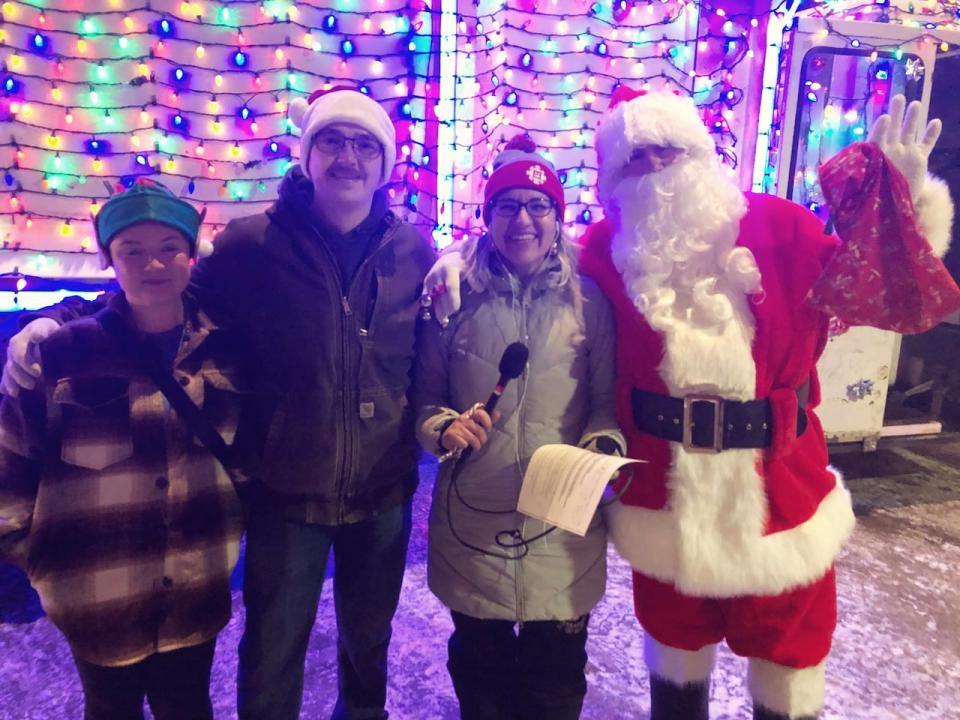 Jordan Henderson, Ryan Henderson, CBC host Elyn Jones, and Whitehorse's 'Garbage Truck Santa,' Wayne Henderson.