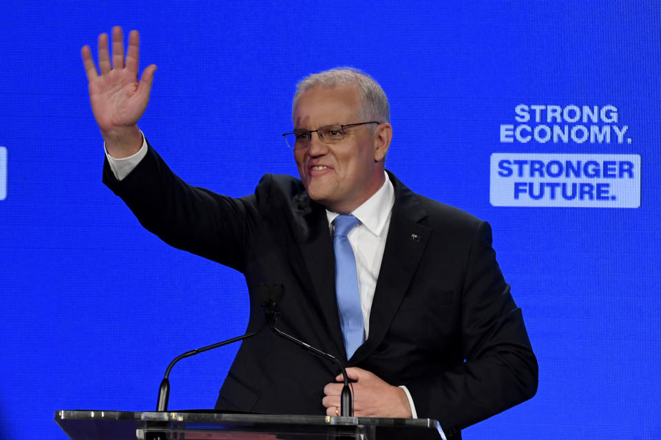 Australian Prime Minister Scott Morrison waves to party faithful during the Liberal Party campaign launch at the Brisbane Convention Centre in Brisbane, Australia, Sunday, May 15, 2022. (Mick Tsikas/AAP Image via AP)