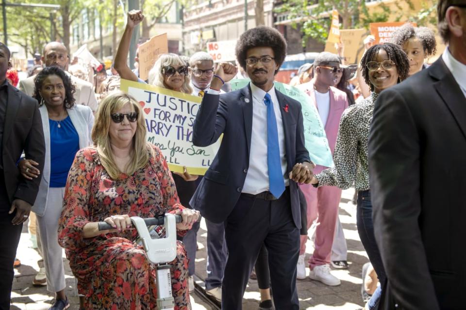 Justin Pearson raises a fist while marching with supporters including Rep. Gloria Johnson, left, on April 12, 2023, in Memphis, Tennessee, before a vote by the Shelby County Commission to reinstate Pearson after he was expelled from the Tennessee state legislature. (Photo by Brandon Dill for The Washington Post via Getty Images)