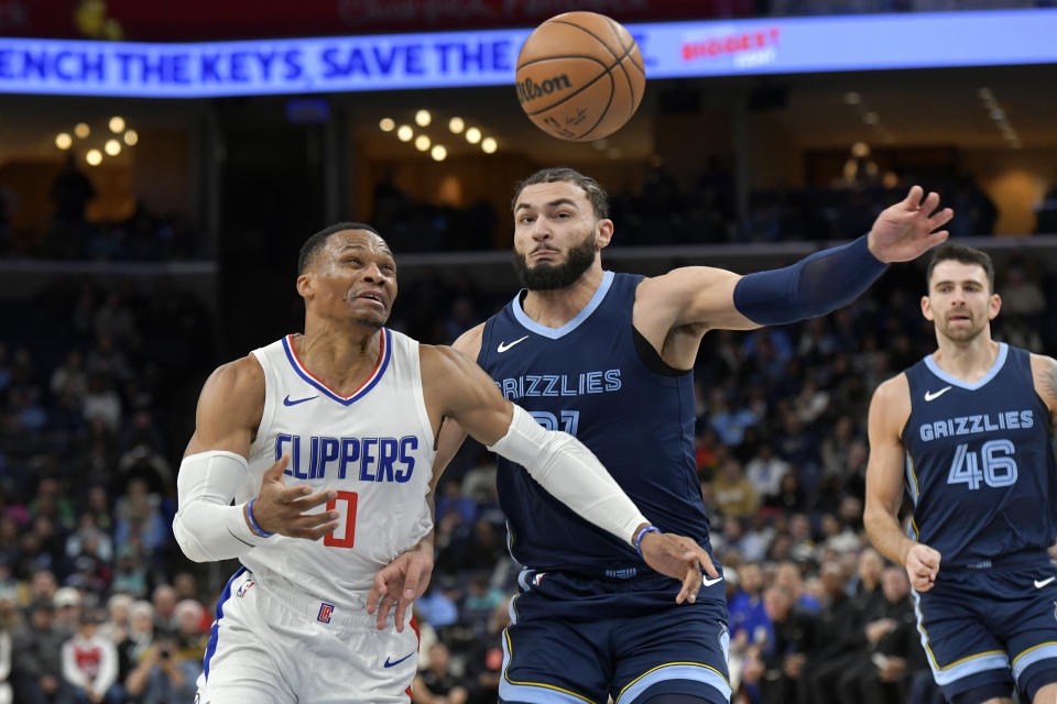 Los Angeles Clippers guard Russell Westbrook (0) and Memphis Grizzlies forward David Roddy (21) watch the ball during the first half of an NBA basketball game Friday, Jan. 12, 2024, in Memphis, Tenn. (AP Photo/Brandon Dill)