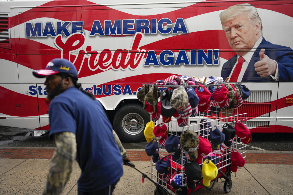 Vendors sell merchandise before Republican presidential candidate former President Donald Trump speaks at a campaign rally Saturday, March 9, 2024, in Rome Ga. (AP Photo/Mike Stewart)