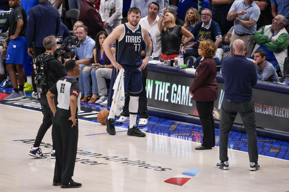 Dallas Mavericks guard Luka Doncic (77) looks on as referee John Conley (79) gives a review on a play against the Boston Celtics during the second half in Game 3 of the NBA basketball finals, Wednesday, June 12, 2024, in Dallas. Doncic fouled out in the fourth quarter. (AP Photo/Sam Hodde)