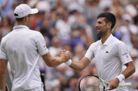 Serbia's Novak Djokovic, right, greets Poland's Hubert Hurkacz at the net after beating him in a men's singles match on day eight of the Wimbledon tennis championships in London, Monday, July 10, 2023. (AP Photo/Alberto Pezzali)