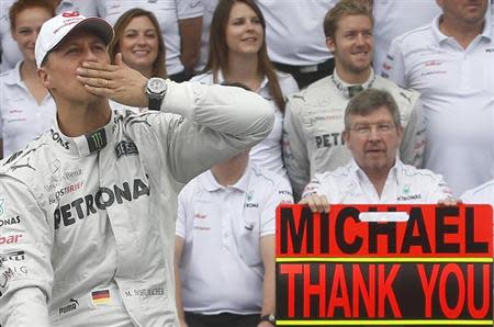 Mercedes Formula One driver Michael Schumacher of Germany gestures during a photo call before the Brazilian F1 Grand Prix at Interlagos circuit in Sao Paulo November 25, 2012. REUTERS/Ricardo Morae