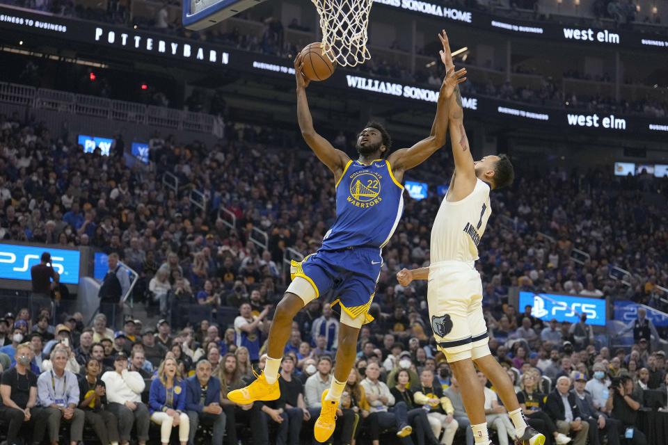 Golden State Warriors forward Andrew Wiggins (22) drives to the basket against Memphis Grizzlies forward Kyle Anderson (1) during the first half of Game 6 of an NBA basketball Western Conference playoff semifinal in San Francisco, Friday, May 13, 2022. (AP Photo/Tony Avelar)