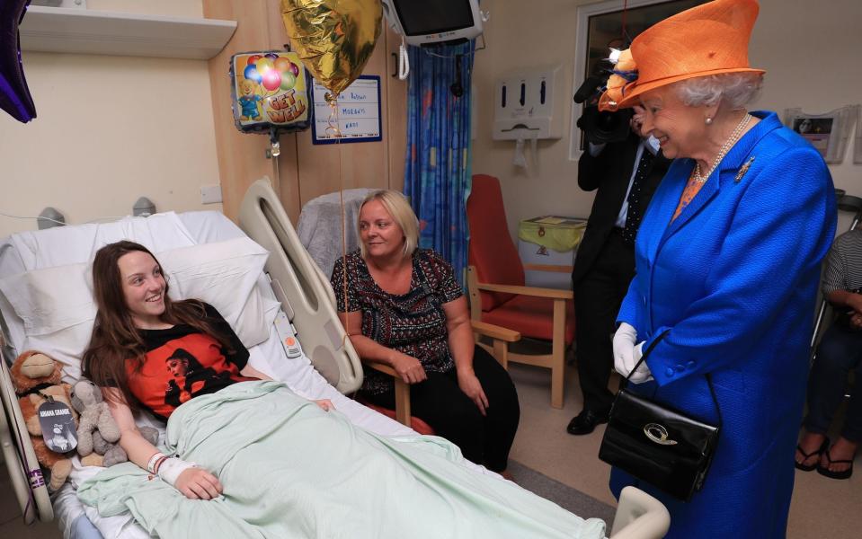 The Queen speaks to Manchester victim Millie Robson, 15, from Co Durham, and her mother, Marie - Credit: Peter Byrne/PA