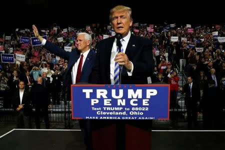 Republican U.S. presidential nominee Donald Trump (R) and vice presidential candidate Mike Pence (L) hold a campaign rally in Cleveland, Ohio, U.S. October 22, 2016. REUTERS/Jonathan Ernst