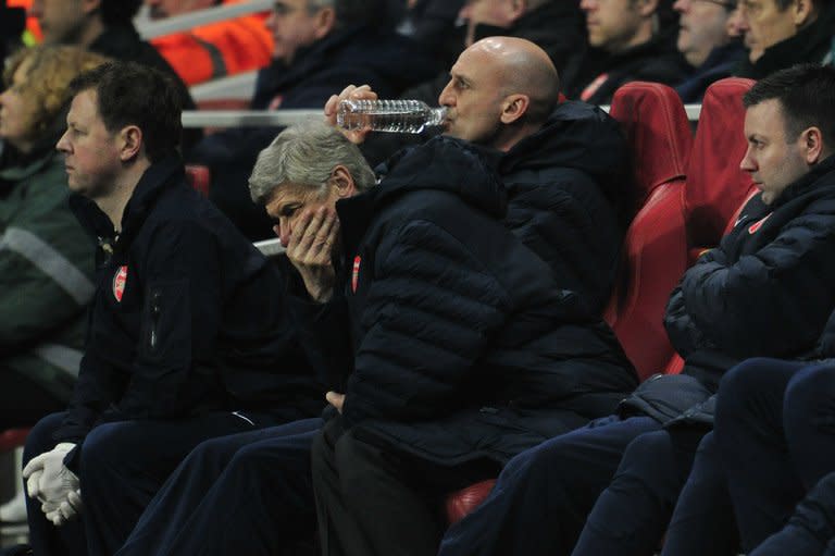 Arsenal manager Arsene Wenger cuts a frustrated figure as he watches his side in the 3-1 home defeat to Bayern Munich, on February 19, 2013. Wenger admitted his side had been outclassed and said it seemed "impossible" to turn the Champions League last 16 tie around