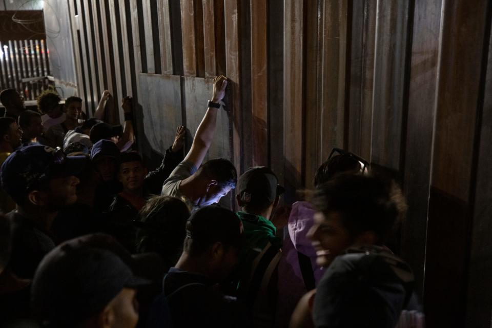 Migrants pleaded with U.S. Customs and Border Protection officers to allow entry into the U.S. as they stood next to a gate on the northbound railroad bridge in Ciudad Juárez that leads into El Paso after a rumor on social media circulated claiming they would be allowed entry to seek asylum.