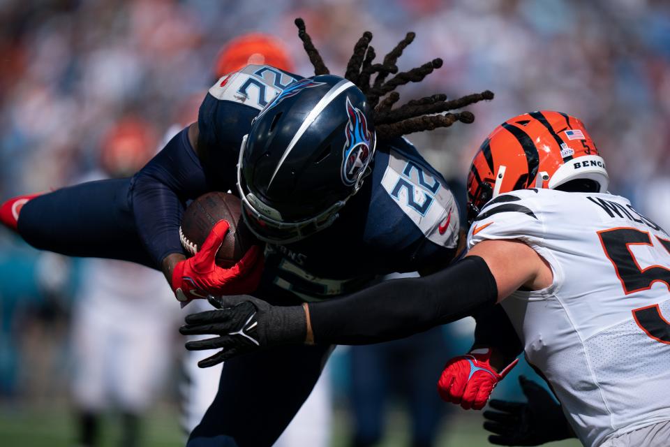 Tennessee Titans running back <a class="link " href="https://sports.yahoo.com/nfl/players/29279" data-i13n="sec:content-canvas;subsec:anchor_text;elm:context_link" data-ylk="slk:Derrick Henry;sec:content-canvas;subsec:anchor_text;elm:context_link;itc:0">Derrick Henry</a> (22) barrels into <a class="link " href="https://sports.yahoo.com/nfl/teams/cincinnati/" data-i13n="sec:content-canvas;subsec:anchor_text;elm:context_link" data-ylk="slk:Cincinnati Bengals;sec:content-canvas;subsec:anchor_text;elm:context_link;itc:0">Cincinnati Bengals</a> linebacker <a class="link " href="https://sports.yahoo.com/nfl/players/32735" data-i13n="sec:content-canvas;subsec:anchor_text;elm:context_link" data-ylk="slk:Logan Wilson;sec:content-canvas;subsec:anchor_text;elm:context_link;itc:0">Logan Wilson</a> (55) during the second quarter at Nissan Stadium in Nashville, Tenn., Sunday, Oct. 1, 2023.