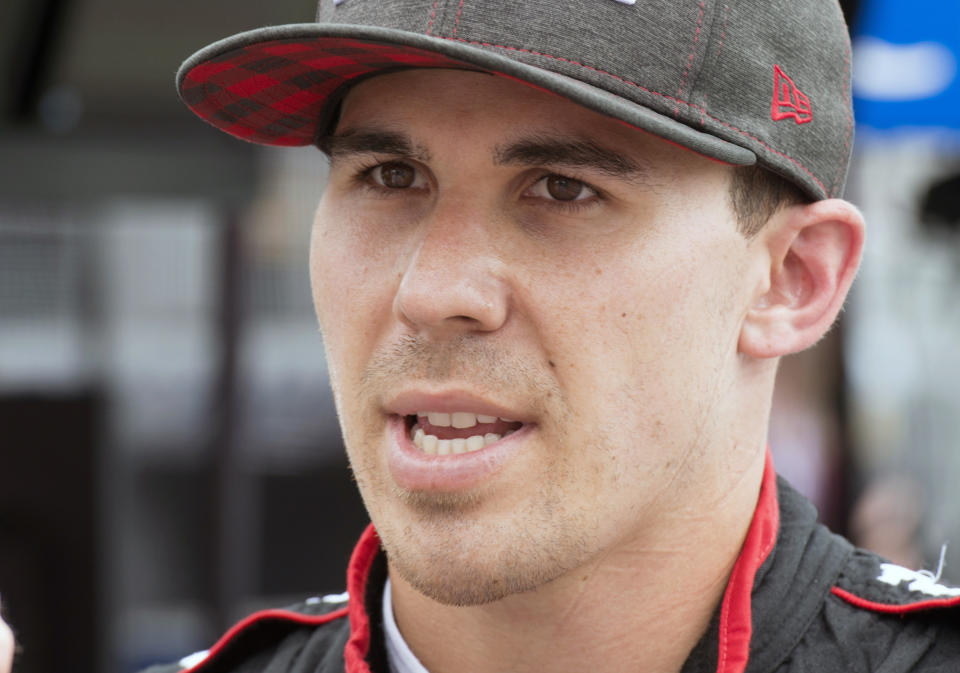 FILE - In this July 13, 2018, file photo, Robert Wickens talks after the second practice session for the Toronto Indy IndyCar auto race in Toronto. Wickens is paralyzed from the waist down from injuries suffered in an August crash at Pocono Raceway. Wickens has been updating his rehabilitation progress on social media and posted a video Thursday of his "first slide transfer as a paraplegic" that showed him moving from a table to his wheelchair. His videos had shown for the past month that he is working daily to move his legs again, but his Thursday, Oct. 25, 2018, post was the first time he publicly confirmed paralysis. (Frank Gunn/The Canadian Press via AP, File)