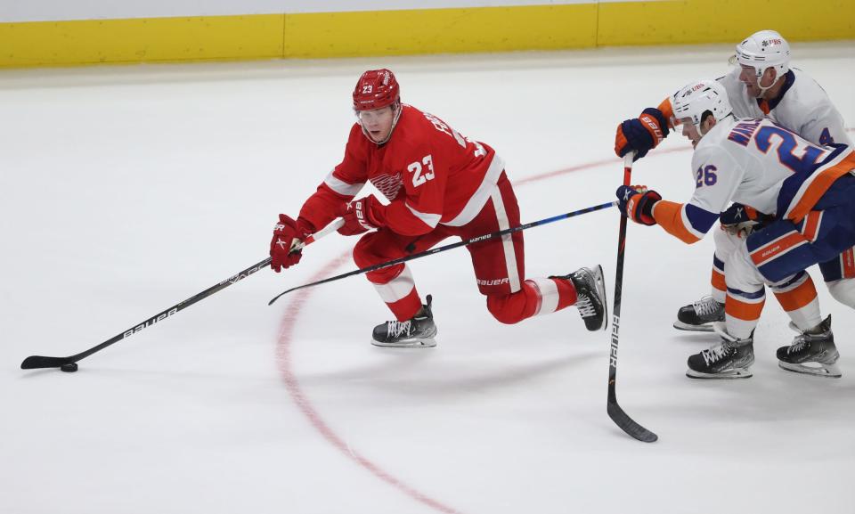 Red Wings right wing Lucas Raymond skates against Islanders right wing Oliver Wahlstrom, foreground, during the second period on Tuesday, Dec. 14, 2021, at Little Caesars Arena.