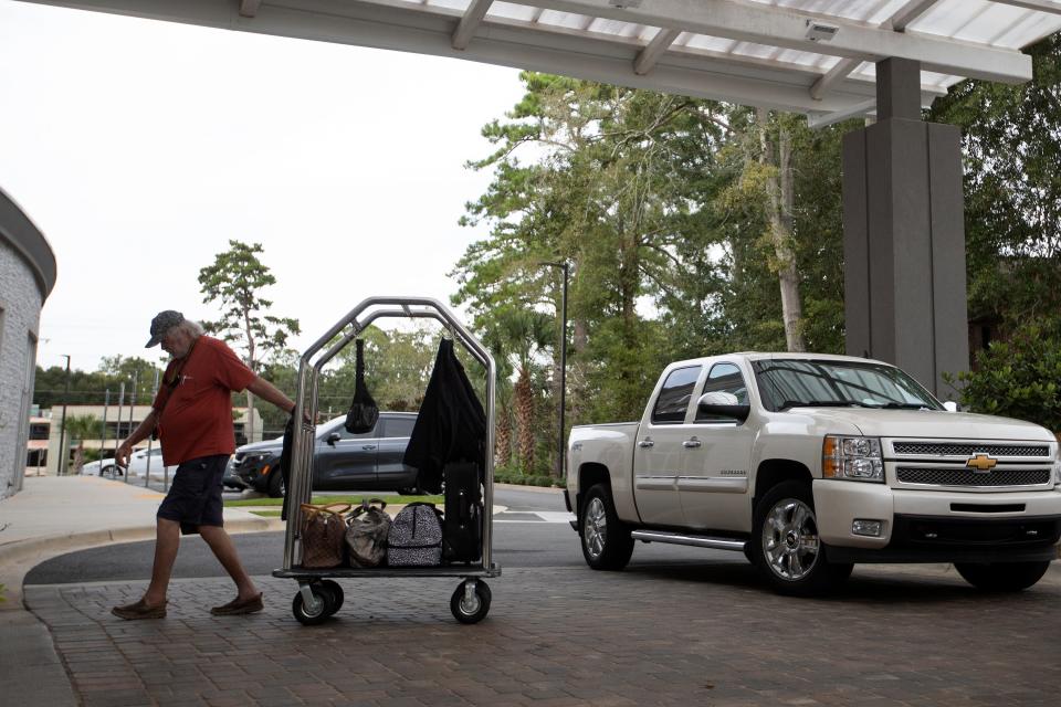 Al Haines brings his belongings into the Holiday Inn Tallahassee East Capital on Tuesday, Sept. 27, 2022. Haines originally booked the hotel room to attend the Florida State University Homecoming football game, but now he and his wife area evacuating the Tampa area in anticipation of Hurricane Ian. 