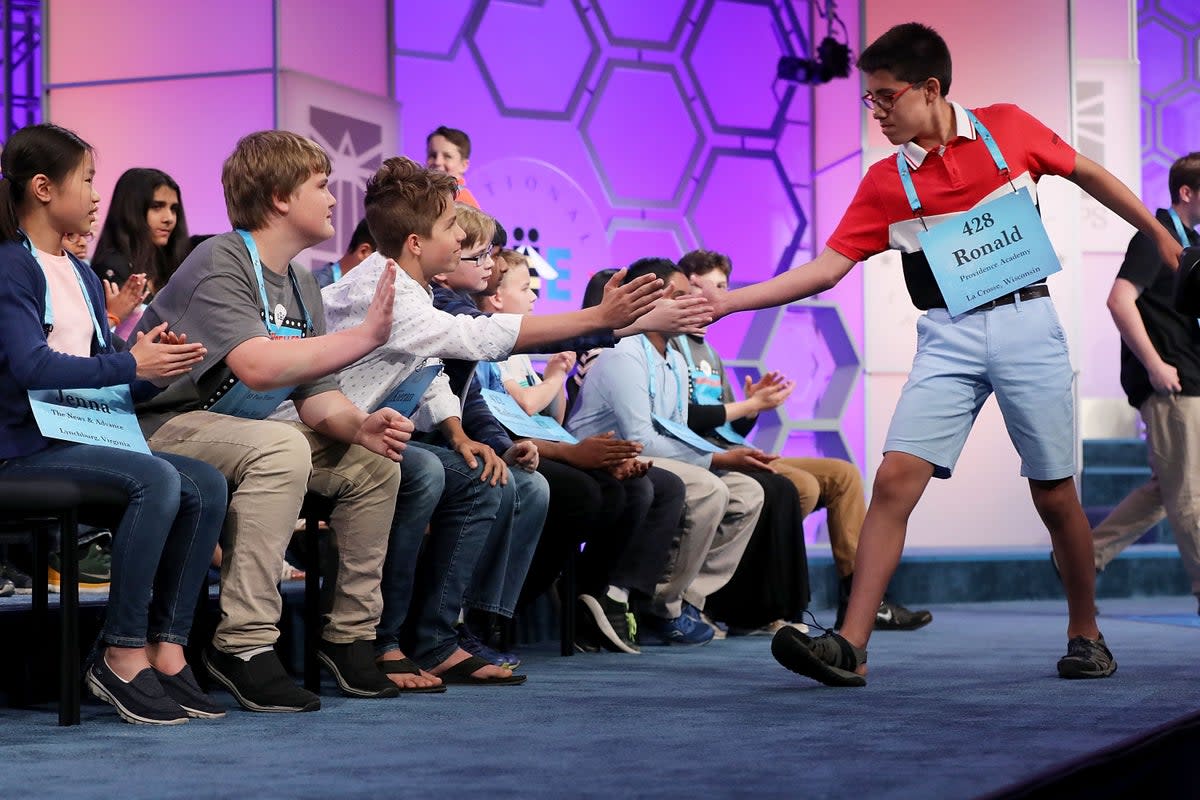 Ronald Walters of Onalaska, Wisconsin, is high-fived by his fellow competitors during the third round of 2018 Scripps National Spelling Bee (Getty Images)