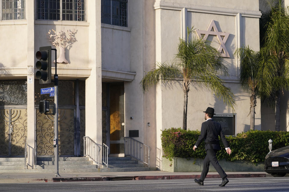 A man walks to the Congregation Shaarei Tefila synagogue in Los Angeles on Saturday, Oct. 7, 2023. (AP Photo/Damian Dovarganes)