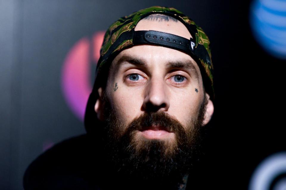 Travis Barker arrives at Beats Music Launch Party at the Belasco Theatre, Friday, Jan. 24, 2014, in Los Angeles, Calif. (Photo by Richard Shotwell Invision/AP)