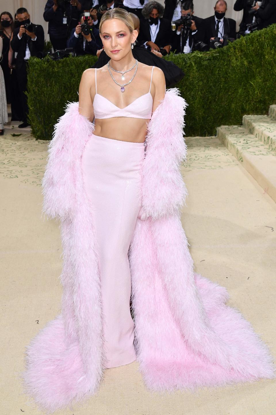 Kate Hudson arrives at the 2021 Met Gala in an all-pink Michael Kors ensemble.